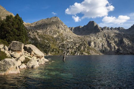 Beautiful landscape of Black lake (Estany negre) in the natural park of Aigestortes y Estany de Sant Maurici, Pyrenees valley with river and lake