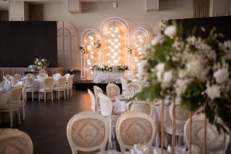 Luxury wedding table setting with flower centerpieces and candles. Wedding day.