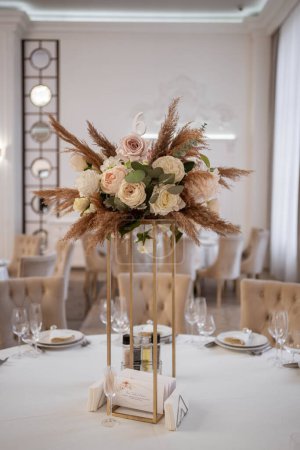 Boho wedding decor. Wedding centerpieces arrangements with dried flowers floristry and candles, boho style. Wedding day.