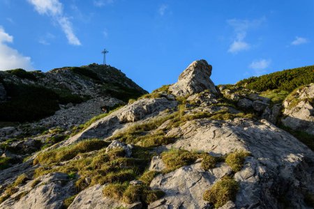 Photo for A cross on the top of the Giewont mountain rising above Zakopane in the Tatra National Park - Royalty Free Image