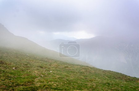 Photo for Mountain ridge with a hiking trail hidden in the clouds. - Royalty Free Image