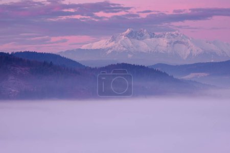 Photo for Landscape in the morning. There is fog in the valley. View of the Tatra Mountains from the Pieniny Mountain Range Slovakia. - Royalty Free Image