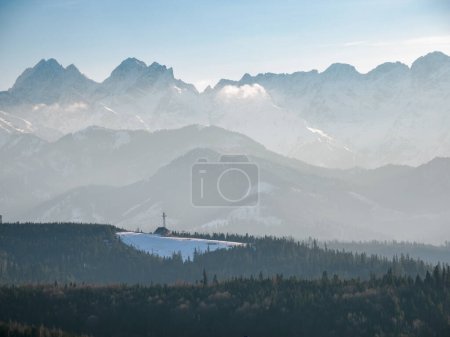 Photo for Mountain landscape..Visible upper station of the ski lift in Jurgow. View of the Tatra Mountains from the Spisz. Lapszanka. Poland. - Royalty Free Image