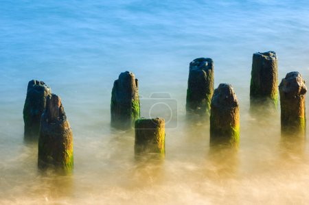 Photo for Seascape. Breakwater in the sun. Leba. Baltic Sea. Poland. - Royalty Free Image