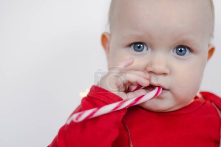 Photo for CChristmas Portrait of a beautiful little child holding a candy cane - Royalty Free Image