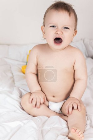 Photo for Baby on a white blanket in a diaper. High quality photo - Royalty Free Image