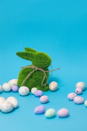 Foto de Easter bunny and eggs on blue background. Celebration layout or card.. High quality photo - Imagen libre de derechos