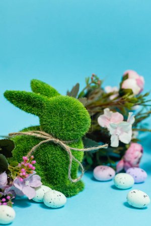 Foto de Easter bunny and eggs on blue background. Celebration layout or card.. High quality photo - Imagen libre de derechos