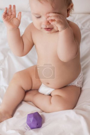 Photo for Baby on a white blanket in a diaper. High quality photo - Royalty Free Image