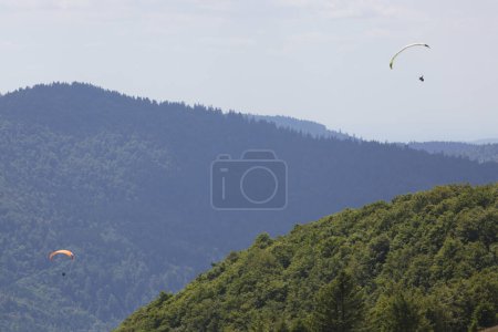 Photo for Paragliders flying over beautiful mountains - Royalty Free Image