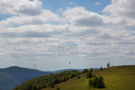 Photo for Paragliders flying over beautiful mountains - Royalty Free Image