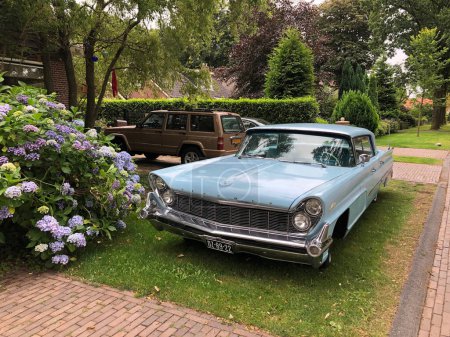 Photo for Old car in yard in suburbia area - Royalty Free Image