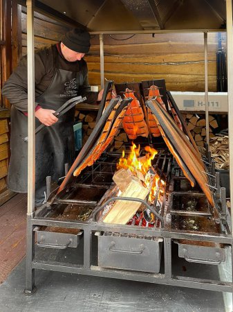 Foto de Países Bajos - 19 de febrero de 2022: Man cooking meat on grill - Imagen libre de derechos