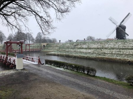 Foto de Molino de viento en la isla cerca del canal en invierno - Imagen libre de derechos