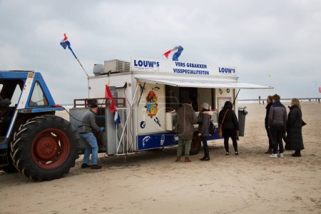 Photo for Tractor with fast food trailer on sea beach in cold day - Royalty Free Image