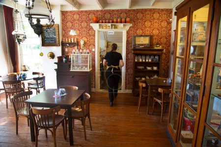 Photo for Back view of Waitress walking in the vintage cafe - Royalty Free Image