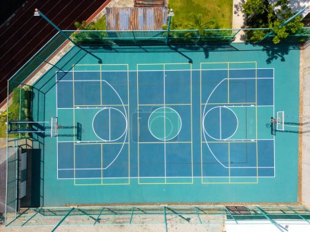 Phuket, Thailand - February 17, 2024: A drone aerial view of an outdoor multi-purpose sports basketball court surface at Headstart International School in Phuket, Thailand.