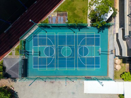 Phuket, Thailand - February 17, 2024: A drone aerial view of an outdoor multi-purpose sports basketball court surface at Headstart International School in Phuket, Thailand.