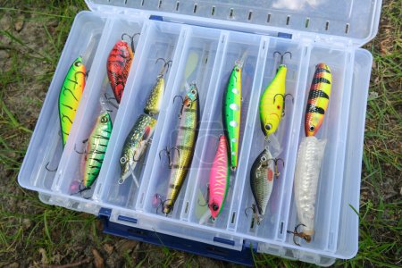 A box of baits for catching fish. Multi-colored lures of different shapes. High quality photo