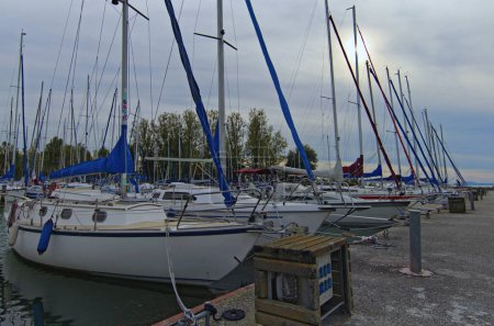 Photo for Detailed view of moored yachts in a harbor yacht club in Lake Balaton, Balatonkenese. Stunning autumn landscape. Travel and tourism concept. - Royalty Free Image