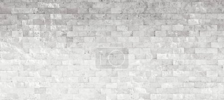Foto de Una imagen de fondo original y hermosa de una pared de gran formato con ladrillos iluminados por la luz solar indirecta. - Imagen libre de derechos