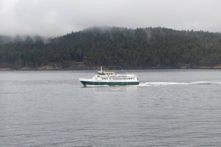 Photo for Anacortes, Washington, United States - 09-11-2021: A view of a small ferry going across the Puget Sound. - Royalty Free Image