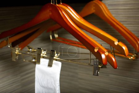 Photo for A view of some wooden hangers in a hotel room closet setting. - Royalty Free Image