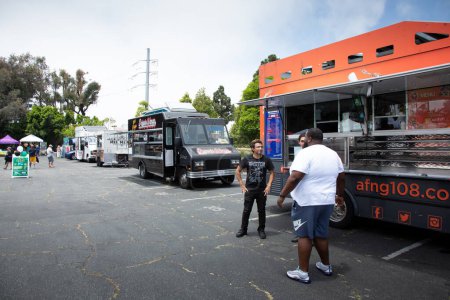 Photo for Los Angeles, California, United States - 05-20-2022: A view of several food trucks seen at the Spicy Green Book Food Market. - Royalty Free Image