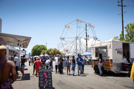 Photo for Los Angeles, California, United States - 05-20-2022: A view of people walking around the Black on the Block festival. - Royalty Free Image