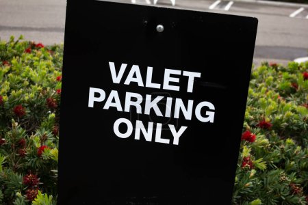 Photo for A view of a traffic sign directing cars to the valet parking area. - Royalty Free Image