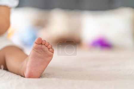 Foto de Una imagen de primer plano captura el pequeño pie desnudo de un bebé, simbolizando el crecimiento y las primeras etapas de la vida. - Imagen libre de derechos