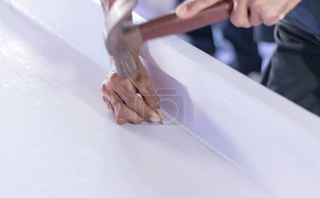 Undertaker was using nails and a hammer to hammer the lid of the coffin closed