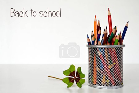 Photo for School supplies on white background. back to school card. colorful pencils and clover leaf - Royalty Free Image