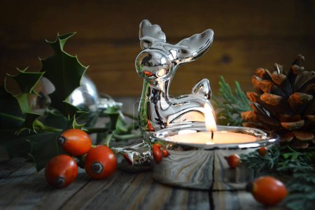 Photo for Christmas composition. burning candle, deer figurine and decorations on wooden table - Royalty Free Image