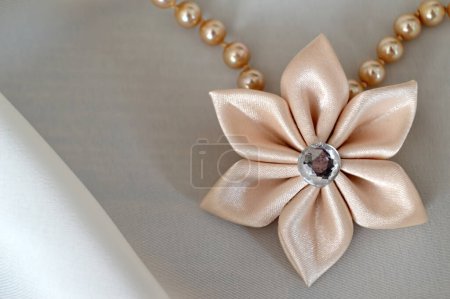 Photo for Pearl neacklace with textile flower pendant - Royalty Free Image