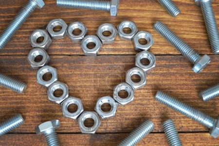 Photo for Happy father 's day card with metal screws and hex nuts on a wooden table. - Royalty Free Image