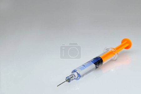 Photo for Injection syringe on grey background with copy space - Royalty Free Image