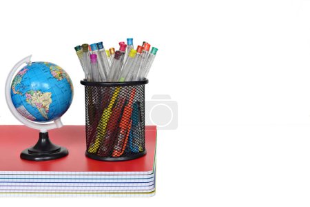 Photo for Back to school concept. school supplies on white table. Globe and color pens on stack of copybooks. copy space for text - Royalty Free Image