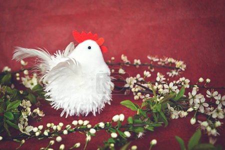 Photo for Easter decoration with toy chicken and branches of spring cherry blossom - Royalty Free Image