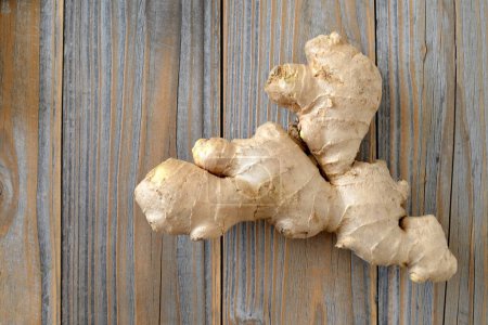 Photo for Ginger root on wooden background with copy space - Royalty Free Image