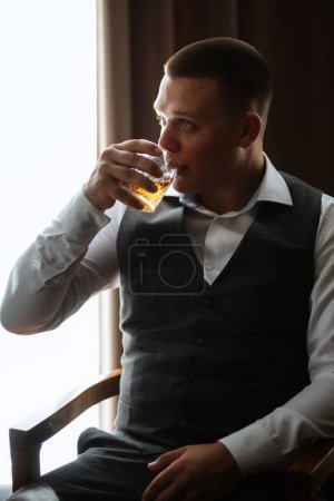 Photo for Portrait of the groom of a man in the morning before the wedding in a gray plaid three-piece suit - Royalty Free Image
