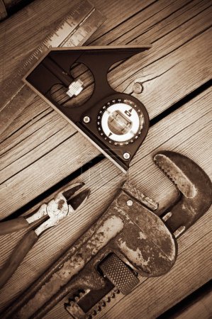 Photo for Sepia Image of Old Vintage Tools on Weathered Wood Vertical - Royalty Free Image