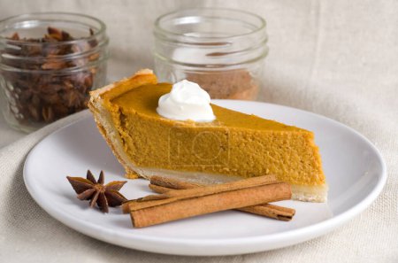 Photo for Macro of Delicious Pumpkin Pie with Cinnamon Sticks, Yogurt and Anise Star Horizontal - Royalty Free Image