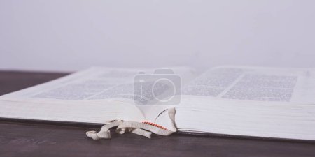 Photo for Open book on a wooden table - Royalty Free Image