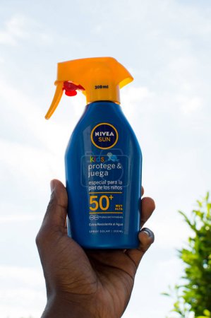Photo for Nivea Sun cream in an Adult male hand - Royalty Free Image