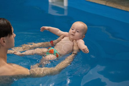 Schwimmtrainer bringen Baby das Schwimmen bei