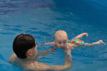 Baby drinking water of swimming pool. Disinfection and cleaning of swimming pool. 