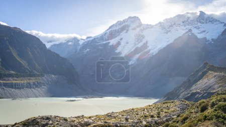 Alpine glacial landscape with huge mountains and lake on a sunny day, Mt Cook, New Zealand.