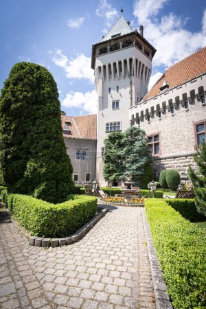 Fairy tale looking beautiful preserved medieval castle with garden in front of it, Slovakia.