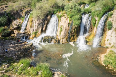 Photo for Waterfalls and stream getting approached by tourists, Turkey. - Royalty Free Image